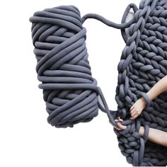 a woman is holding onto a large rope like object that looks like a snake's tail