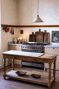 a kitchen with an old fashioned stove and wooden table in front of the counter top