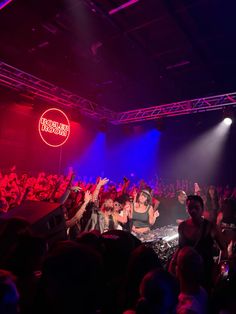 a group of people standing on top of a stage in front of a large crowd