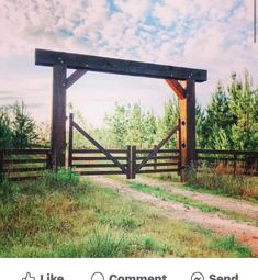 an image of a wooden gate in the middle of a field with grass and trees