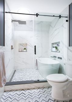 A second-floor hall bath has a wet room with a soaking tub on one side and shower on the other. It is separated from the toilet and vanity by a glass frameless shower door. A newly installed sky tunnel window brings tons of light into a previously windowless space. The toilet was moved and shelving now frames the vanity, not visible in the photo, to the right of the toilet. Tub Shower Toilet Layout, Shower Tub Toilet Room, Bathroom Jacuzzi Tub Ideas Glass Showers, Shower With A Tub In It, Soaking Tub In Shower Walk In, Bathroom Ideas With Soaking Tub, Bathroom With Low Window, Tube Inside Shower Ideas, Window In Wet Room