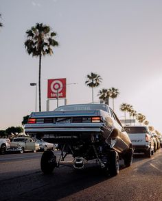 a car that is sitting on the side of the road with it's hood up