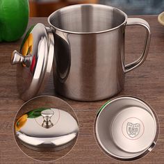 a stainless steel cup and saucer sitting on a wooden table next to two plates