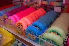 there are many different colors of soaps in the display case at the toy store