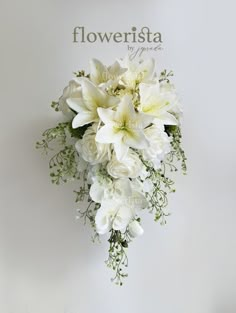 a bouquet of white flowers sitting on top of a sign that says floweristaa