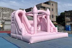 an inflatable pink castle is on the ground