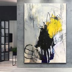 an abstract painting is displayed on the wall