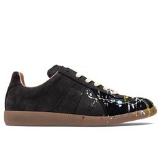 World renown French luxury brand Maison Margiela produces some of the finest pieces of today’s menswear, fine jewelry, footwear, and other goods. Created by Martin Margiela, the collections showcase deconstructive and avant-garde designs with unique concepts and unconventional craftsmanship. Pictured is the Maison Margiela Replica Low Top Suede Paint Drop in Black/Multi. Leather upper Logo patch to tongue Rubber outsole Style no: S57WS0240 P1892 963 Suede Paint, Maison Margiela Replica, French Luxury Brands, Margiela Replica, Sneaker Boutique, Paint Drop, Boutique Design, Paint Splatter, Cotton Lace