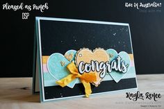 a close up of a card with the words congrats on it and a yellow ribbon