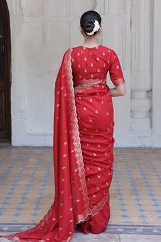 Red saree crafted in moonga silk with gold toned mughal flora vine woven detail along the scallop border and damask butti detail. Paired with a matching half sleeves closed round neck blouse. - Aza Fashions Red Cotton Silk Lehenga With Traditional Drape, Red Cotton Silk Pre-draped Saree For Wedding, Red Cotton Silk Choli With Traditional Drape, Traditional Red Cotton Silk Choli, Red Cotton Silk Lehenga With Pallu, Red Silk Kurta For Puja, Fitted Red Pre-draped Saree For Eid, Festive Red Cotton Silk Pre-draped Saree, Red Zari Work Blouse Piece In Cotton Silk