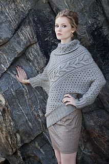 a woman standing in front of a rock formation wearing a sweater and skirt with high heels