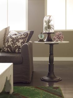 a living room scene with focus on the end table and sofa in the foreground