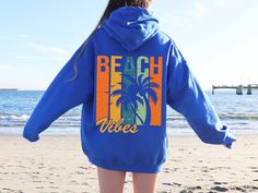 Beach Vibes Hoodie, Beach Sweatshirt, Summer Sweatshirt ✅ Made using advanced DTF technology and professional  heat press, our shirts are designed with high quality materials. 🔷 HOW TO PLACE YOUR ORDER? 🔷 Please be sure to carefully review the size, color, and design options provided in this listing. ✅ Select your desired size and shirt color from the available menus. ✅ Fill in the customization box with your preferred design color. You can refer to the listing photos to see the color choices. Vacation Hoodie With Relaxed Fit And Long Sleeves, Blue Hooded Beach Tops, Blue Hooded Tops For Beach, Blue Hooded Top For Beach, Blue Hooded Tops For The Beach, Relaxed Fit Long Sleeve Hoodie For Vacation, Vacation Long Sleeve Hoodie With Graphic Print, Vacation Graphic Print Long Sleeve Hoodie, Long Sleeve Graphic Hoodie For Vacation