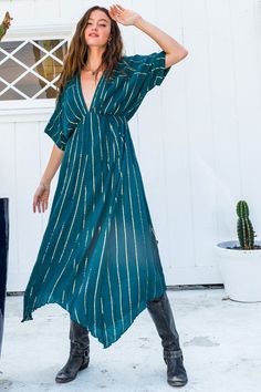 The Santorini Cover Up is a versatile, lightweight dress that can be easily worn to the beach, or paired with neutral wedges and statement earrings for date night! Featuring a plunge neckline, dolman sleeves, and a gold striped print - this is the perfect coverup for your next vacay! Fit: This cover up has a relaxed fit with a dropped waist Length: This cover up hits around the lower calf to ankles Fabric: 100% Rayon / 100% Cotton Lining The fabric is sheer, lightweight, and contains little to n Neutral Wedges, Oversize Sleeves, Lightweight Dress, White Turquoise, Plunge Neckline, Teal And Gold, Gold Stripes, Mid Dresses, Kimono Sleeve