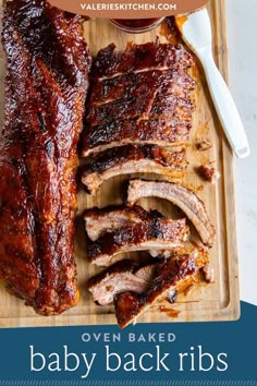 baby back ribs on a cutting board with the words oven baked baby back ribs above it