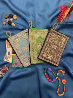 three books and beads on a blue cloth