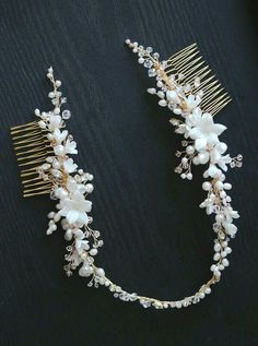 a hair comb with flowers and pearls on it