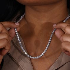 This Diamond Tennis Necklace is a beautiful statement piece made with 4.0 MM Round Lab Grown Diamonds on a Tennis Chain. Show your unique style with this eye-catching and elegant diamond necklace. "𝐓𝐨𝐠𝐞𝐭𝐡𝐞𝐫 𝐰𝐞 𝐜𝐚𝐧 𝐦𝐚𝐤𝐞 𝐭𝐡𝐞 𝐰𝐨𝐫𝐥𝐝 𝐚 𝐛𝐞𝐭𝐭𝐞𝐫 𝐩𝐥𝐚𝐜𝐞 𝐟𝐨𝐫 𝐥𝐢𝐯𝐢𝐧𝐠, 𝐥𝐞𝐭’𝐬 𝐠𝐨 𝐰𝐢𝐭𝐡 𝐦𝐢𝐧𝐢𝐧𝐠-𝐟𝐫𝐞𝐞 𝐝𝐢𝐚𝐦𝐨𝐧𝐝𝐬 𝐚𝐧𝐝 𝐡𝐚𝐧𝐝 𝐨𝐯𝐞𝐫 𝐚 𝐛𝐞𝐭𝐭𝐞𝐫 𝐭𝐨𝐦𝐨𝐫𝐫𝐨𝐰 𝐚𝐧𝐝 𝐜𝐥𝐞𝐚𝐧 𝐞𝐚𝐫𝐭𝐡 𝐭𝐨 𝐭𝐡𝐞 𝐜𝐨𝐦𝐢𝐧𝐠 𝐠𝐞𝐧𝐞𝐫𝐚𝐭𝐢𝐨𝐧𝐬. Dazzling Diamond White Necklace With Diamond Accents, Dazzling Round Necklace For Formal Occasions, Luxury Diamond White Necklace With Prong Setting, Luxury Moissanite Necklace With Brilliant Cut, Fine Jewelry Crystal Diamond Necklace, Luxury Moissanite Necklaces For Formal Occasions, Round Cut Crystal Diamond Necklace, Vvs Clarity Round Diamond Bridal Necklace, Vvs Clarity Diamond Bridal Necklace