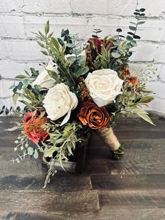 a bouquet of flowers sitting on top of a wooden table