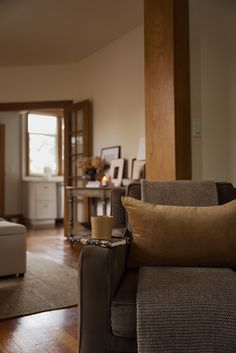 a living room filled with furniture and a coffee cup on top of a wooden table