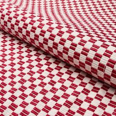 a red and white checkered fabric is folded on top of the tablecloths