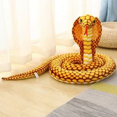 a stuffed snake is sitting on the floor