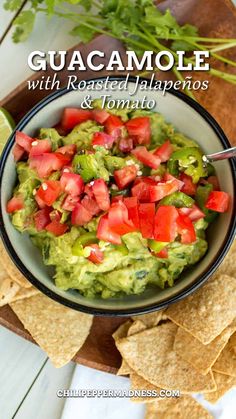 guacamole with roasted jalapenos and tomatoes in a bowl surrounded by tortilla chips