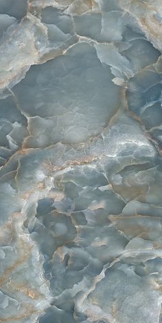 an abstract marble pattern in blue and grey tones with gold highlights on the edges, as seen from above