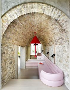 a pink couch sitting in the middle of a room