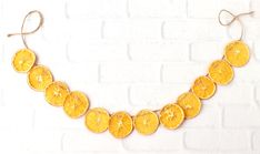 an orange slice necklace hanging on a brick wall