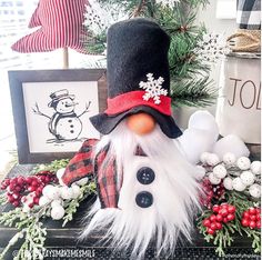 a snowman is sitting in front of a christmas tree