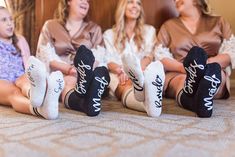 three women sitting on a bed with their feet up