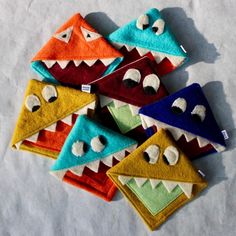 several small stuffed animals are arranged in the shape of shark's teeth on a sheet of paper