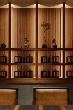 a room with several bookshelves filled with plants