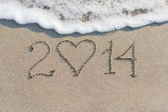 two hearts drawn in the sand at the beach