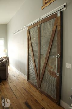 a living room with wooden floors and sliding doors