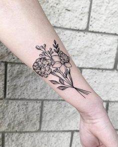 a woman's arm with flowers on it