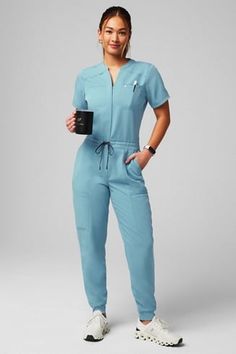 Empower Scrub Jumpsuit - Yitty Dentist Scrubs Woman, Female Doctor Photoshoot, Peds Nurse Outfit, Nurses Scrubs Outfits, Nurse Style Scrubs Fashion, Scrubs Jumpsuit, Doctor Outfit Ideas, Scrubs Uniform Aesthetic, Nursing Outfits Scrubs