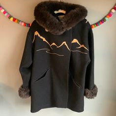 Vtg 87 Laparka Canada Wool Coat. Blanket Stitch Front Pockets. Horn Button Closure. Beautiful Mountain Embroidered Stitching Front And Back. Faux Fur Cuffs And Faux Fur Removable Hood. Fits Sz Medium Length 31” Chest 24” Shoulders 23” Sleeve 30” Retro Embroidered Fall Outerwear, Retro Embroidered Winter Outerwear, Vintage Long Sleeve Parka For Fall, Fall Vintage Long Sleeve Parka, Vintage Embroidered Winter Outerwear, Hooded Embroidered Fall Outerwear, Vintage Brown Embroidered Outerwear, Vintage Embroidered Hooded Outerwear, Fur Cuffs