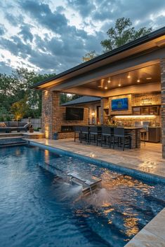 an outdoor living area with a pool and bar