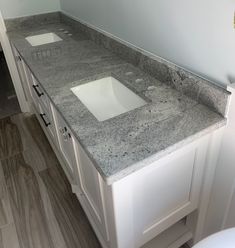 a bathroom counter top with two sinks in it