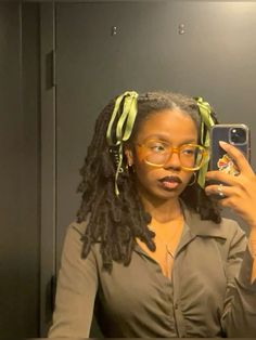 coquette, pigtails, ponytail hairstyles, olive green, green aesthetic, bows, ribbons, protective styles for natural hair, soft girl aesthetic black woman, ribbon hairstyles, natural hair, faux locs, medium length faux locs, faux locs hairstyles, hair inspo, mirror selfie, big glasses, chunky glasses, glasses aesthetic, coquette hairstyles, brown lip liner, lip gloss combo, coquette aestethic, cute girl pfp, soft locs, black girls hairstyles, sage green aesthetic, earthy aesthetic, earthy black woman aesthetic, earthy outfit, pretty girl aesthetic, instagram story inspo, hair bow, ribbon aesthetic, satin ribbon, hoop earrings, protective style, preppy outfit inspo Styling Natural Locs, Short Brown Faux Locs, Dark Purple Locs Black Women, Messy Loc Styles, Cute Short Locs Hairstyles, Micro Locs With Bangs, Loc Pigtails Style, Wedding Hair Locs, Hair Scarf Styles Black Women