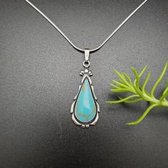 "Visit our on-line shop at: Etsy.com/shop/AlbuquerqueDesigns *sterling silver necklace pendant *long teardrop pendant with silver snack chain necklace 18\" *southwestern jewelry *kingman turquoise *calibrated pre-cut stones: 23x10mm teardrop shape *all jewelry items are made to ship, slight variations in stones will occur comparing to pictures. *size of a penny is 19mm or a dime is 18mm in diameter for comparing size with jewelry items. *handcrafted in USA *free small convenient gift box *free s Sterling Silver Turquoise Teardrop Necklace, Turquoise Teardrop Pendant Necklace, Sterling Silver Teardrop Turquoise Necklace, Turquoise Heart Earrings, Southwestern Necklace, Carnelian Necklace, Turquoise Stud Earrings, Turquoise Drop Earrings, Snake Chain Necklace