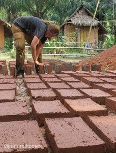 a man is placing bricks in the ground