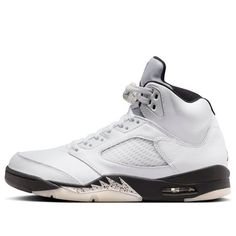 The Air Jordan 5 Retro 'White Black' is a classic colorway reimagined. Featuring a clean white leather upper contrasted by black accents on the midsole and trim, this shoe is a timeless look. The iconic metallic silver tongue adds a touch of retro flair, reminiscent of Jordan's high-flying era. White Basketball Shoes With Contrast Sole For Streetwear, Urban White Basketball Shoes With Contrast Sole, White Urban Basketball Shoes With Contrast Sole, White Leather Basketball Shoes For Streetwear, Classic White Basketball Shoes With Contrast Sole, Urban White High-top Sneakers With Contrast Sole, White Mid-top Custom Sneakers With Contrast Sole, Classic Leather Basketball Shoes With White Sole, Urban White Basketball Shoes With Rubber Sole