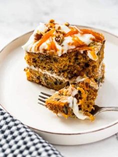 two pieces of carrot cake on a plate with a fork