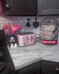 a pink toaster sitting on top of a kitchen counter