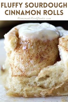 cinnamon rolls with icing on top and the words fluffy sourdough cinnamon rolls