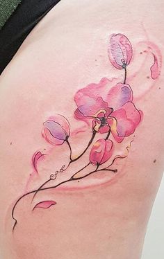 a woman's back with pink flowers painted on it