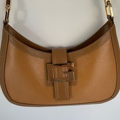 Gucci 2-Tone Tan Leather Handbag With Eye-Catching Gold-Tone Signature “G” Symbol. Size: Width: About 9 Inches At Top About 11 Inches At Bottom Length: About 6 Inches At Middle About 7 Inches At Sides Base: About 1 1/4 Inches Buckle: About 2 1/4 X 1 1/2 Inches Interior: Gucci Signature Fabric Lining - Zipper Pocket Strap: About 11 1/2-Inch Drop Made In Italy Excellent Condition - Never Used Gucci Dust Cover Gucci Shoulder Bag With Gold-tone Hardware For Shopping, Gucci Bags With Metal Hardware For Work, Gucci Bags With Gold-tone Hardware For Work, Gucci Shoulder Bag With Gold-tone Hardware For Office, Gucci Shoulder Bag For Work With Branded Hardware, Gucci Satchel Shoulder Bag For Work, Gucci Satchel For Work, Chic Gucci Shoulder Bag For Work, Gucci Rectangular Shoulder Bag For Work